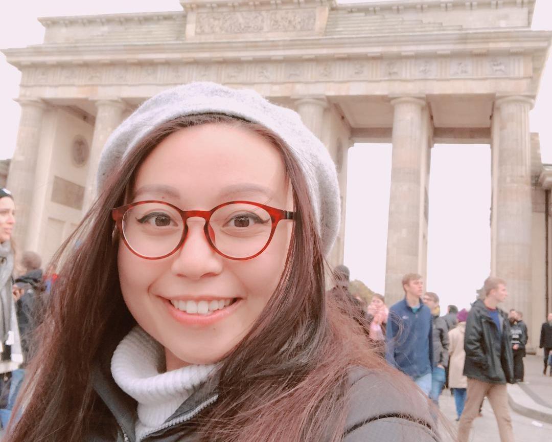 Graduate School of Business student Nguyen Tram in front of Germany\'s Brandenburg Gate