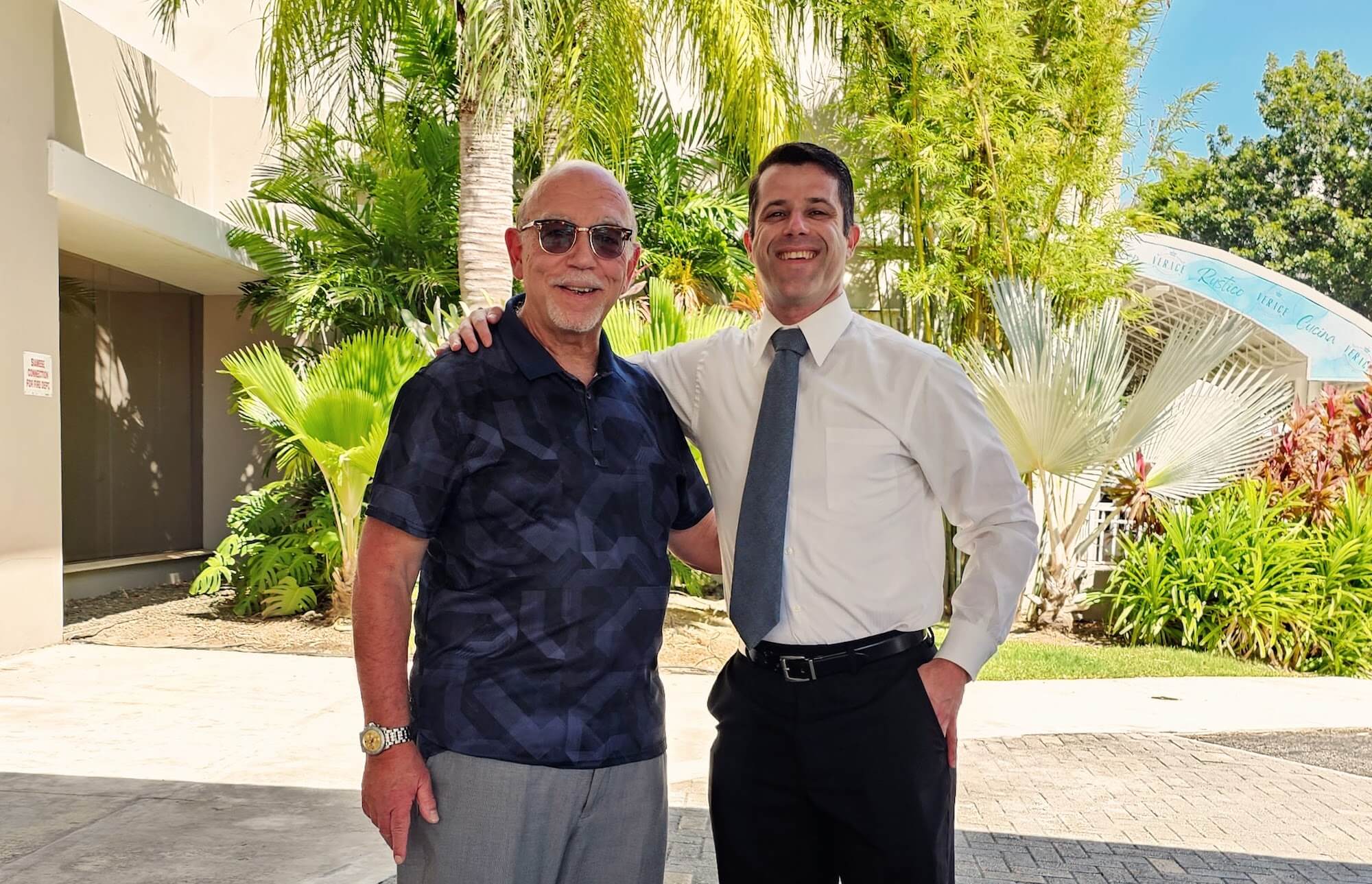 Graduate School of Business Professor faculty members Charles Priolo and Dr. Gavin Goldstein outside a convention hall in Puerto Rico.