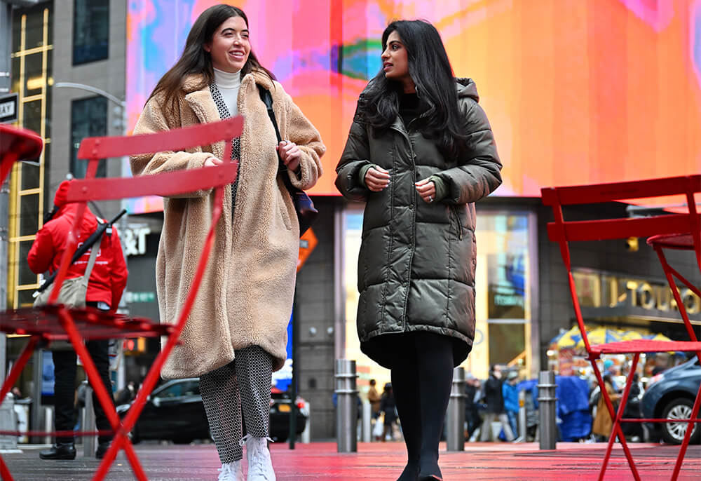 Rima Aranha and Nadia Ambarsom walking and talking outside of Touro University in Times Square